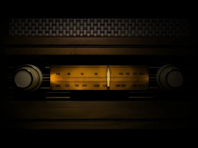 Video still: close-up of a vintage radio tuning dial